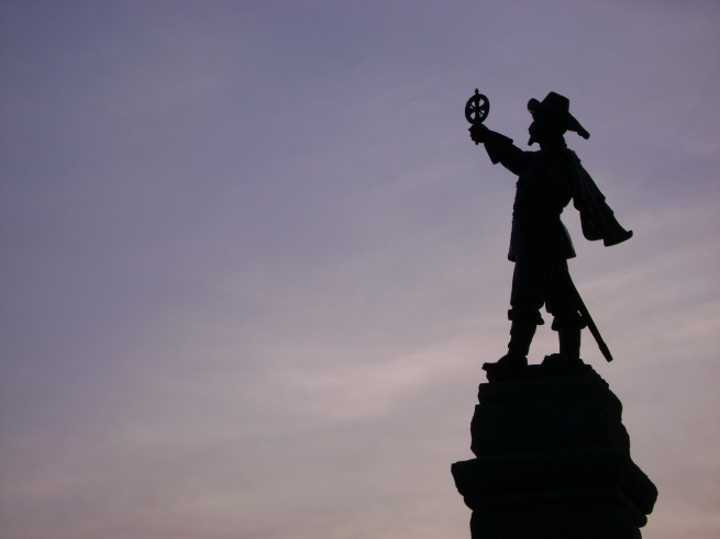 Samuel de Champlain's statue is silhouetted against the twilight sky